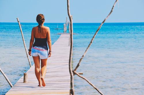 A woman walking by the sea