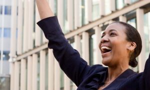 woman happy exciting celebrates tall business buildings