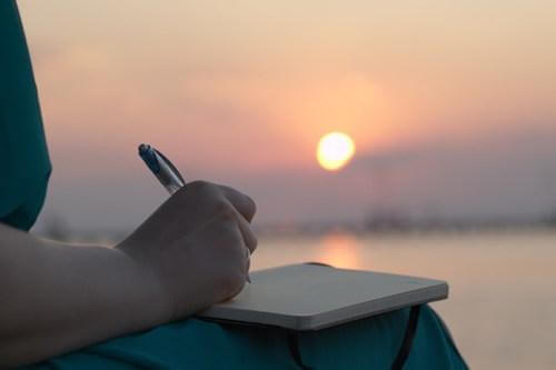 woman writing in a journal