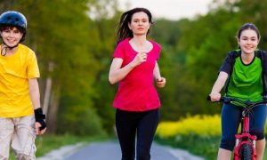 woman daughter son exercise jogging riding bike skating in park