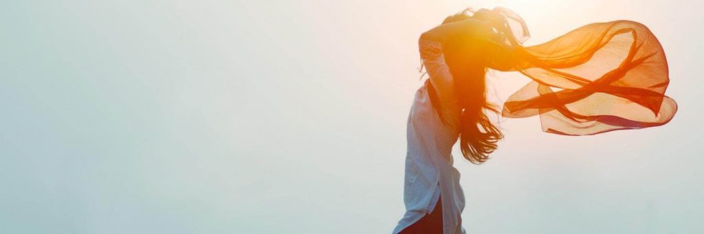 woman stands gratitude life in sunny sky