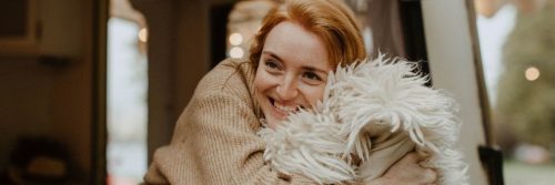 woman happily enjoyably hugs pillow