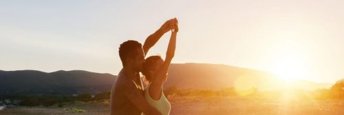 couple dances aerobics on field in sunny sky