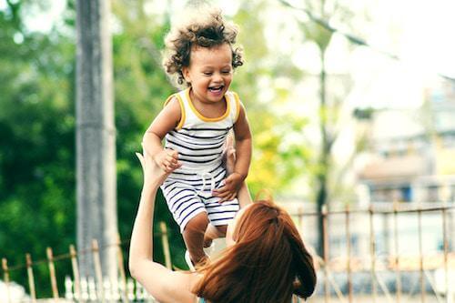 mum throwing son in the air