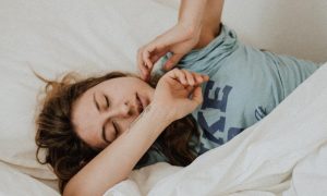 woman tiredly sleeps having trouble to have good night sleep