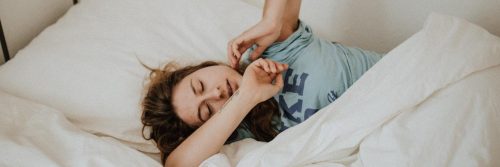 woman tiredly sleeps having trouble to have good night sleep