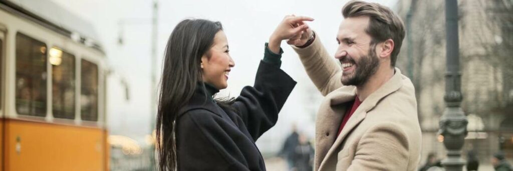 Couple Holding hands and happily dancing in broad daylight