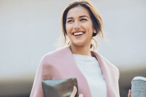 Financially independent woman happy in a pink jacket