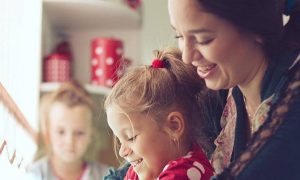 woman happily takes care of kids in kindergarten