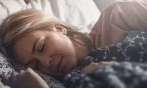 woman sleeping tightly well on bed