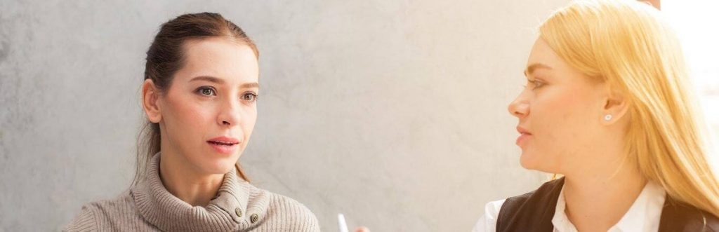 two women talking looking at each other