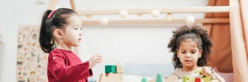 two girls play lego jigsaw puzzle