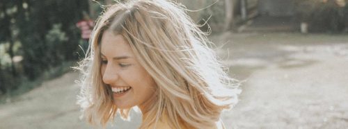 short blonde hair woman happily smiles