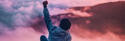 person raises hand sit gratitude life in cloudy foggy weather