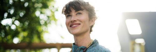 woman happily smiling in sunny sky