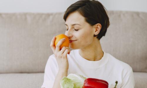 Woman smelling an orange