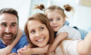 happy family smiles taking selfie in living room