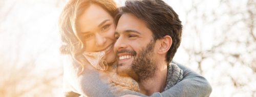 couple happily hugged smiles in beautiful sunny sky