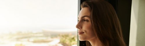 lady standing beside window gratitude enjoy moments