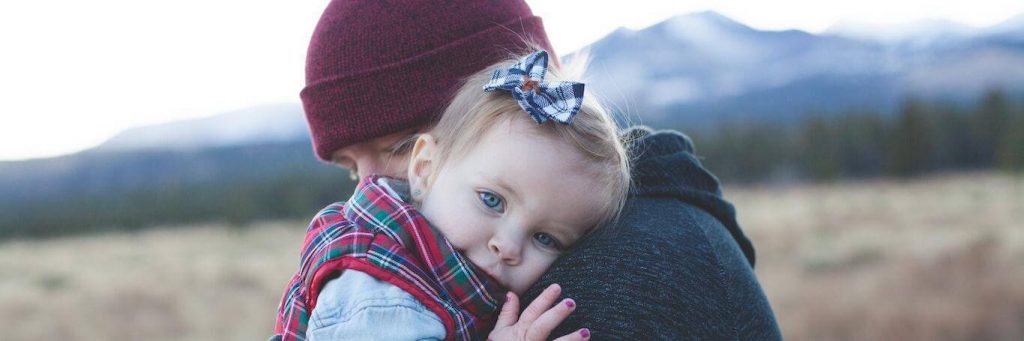 man carrying hugging little adorable daughter