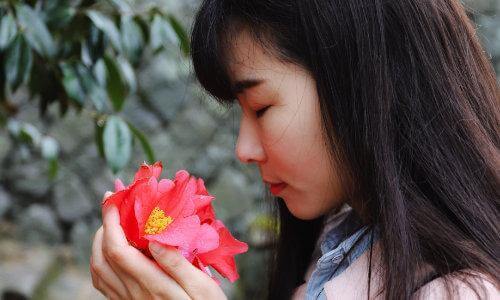 woman smelling flower