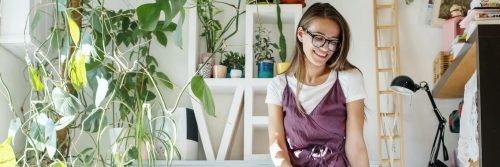 young woman shy face sitting laughing modelling in artwork room