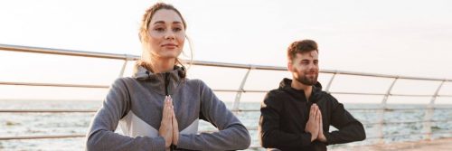 couple sits on bridge practices meditation