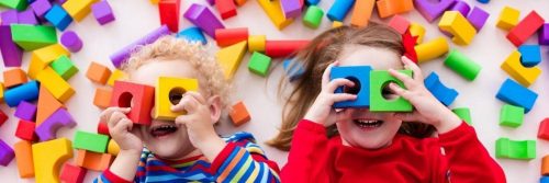 two adorable children play toys legos