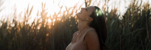 woman stands on field happily smiling gratitude life showing unconditional love to nature