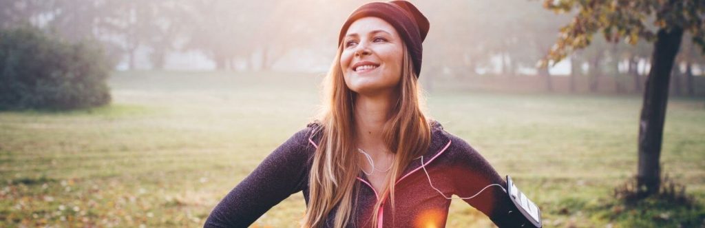 blonde straight hair woman happily stands smiles enjoys nice foggy weather