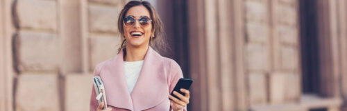 Financial Wellbeing wealthy woman in a pink top feeling happy