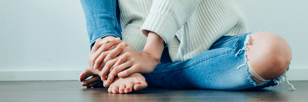 two hands doing massage for feet