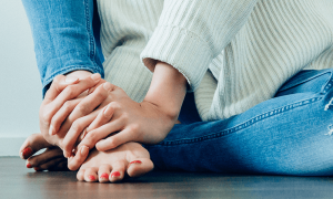 two hands doing massage for feet