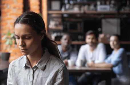 woman with low confidence looking sad and dejected at work