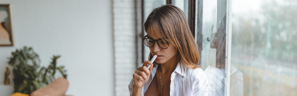 woman thinks concentrates on reading stands next to door