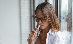 woman thinks concentrates on reading stands next to door