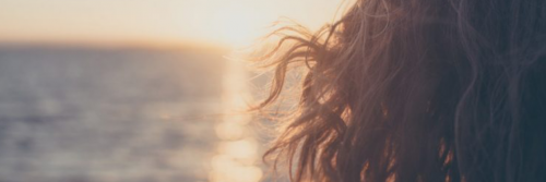 woman hair flying in sunset sky