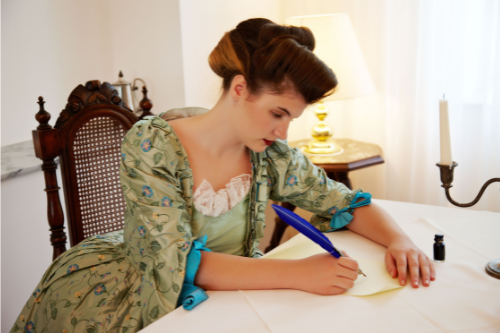 woman sits in living room writing goodbye letter to loving maternal grandmother