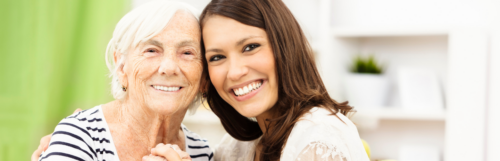 grandmother granddaughter happy faces smiling posing for photos in living room