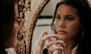 Woman looking at reflection in mirror