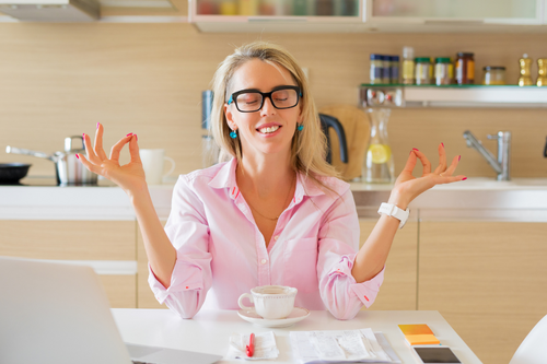 Financially Free and Calm Housewife Sitting in Kitchen