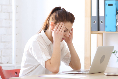 Woman Frustrated and Tense with Headache