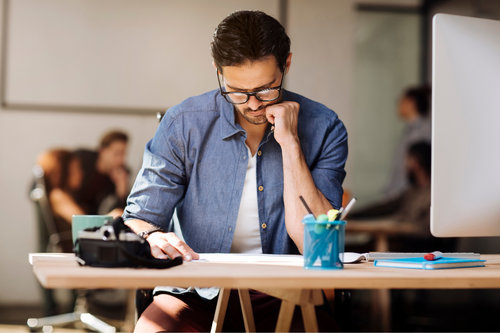 Young man focusing on his work at the office