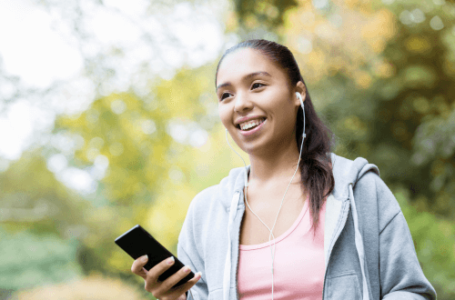 girl with dark hair and headphones, exercising to music