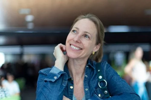 woman in blue jacket feeling grateful