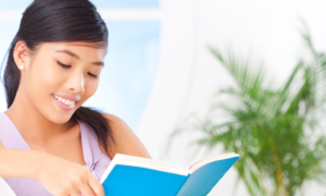 Asian woman reading happily