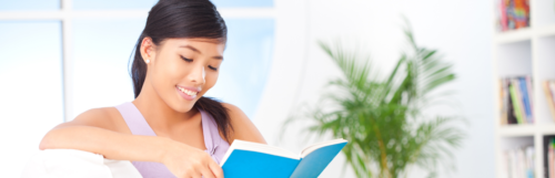 Asian woman reading happily